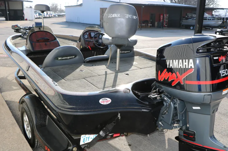 Slide: The Image of 2004 Ranger 185 VS boat with Yamaha VMAX 150 outboard motor in a parking area. - 8