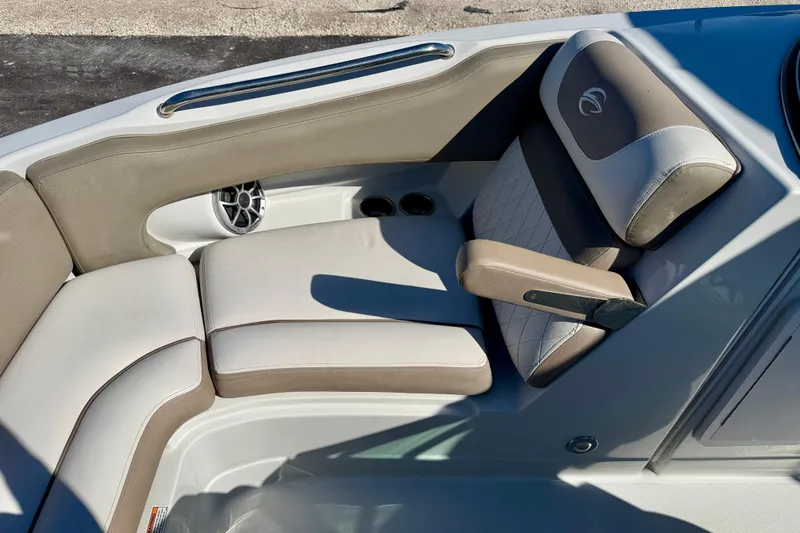Slide: The Image of 2023 Crownline Eclipse E235 XS boat interior with beige seating and speaker. - 10