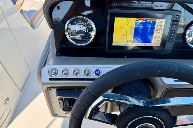 Slide: The Image of 2023 Crownline Eclipse E235 XS dashboard with GPS and control panel. - 15