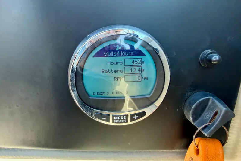 Slide: The Image of Dashboard display of 2023 Crownline Eclipse E235 XS showing hours, battery, and RPM. - 19