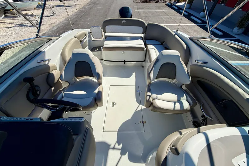 Slide: The Image of 2023 Crownline Eclipse E235 XS boat interior with seating and steering wheel. - 21