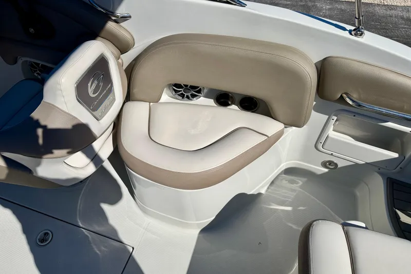 Slide: The Image of 2023 Crownline Eclipse E235 XS boat interior with beige seating and speaker. - 24