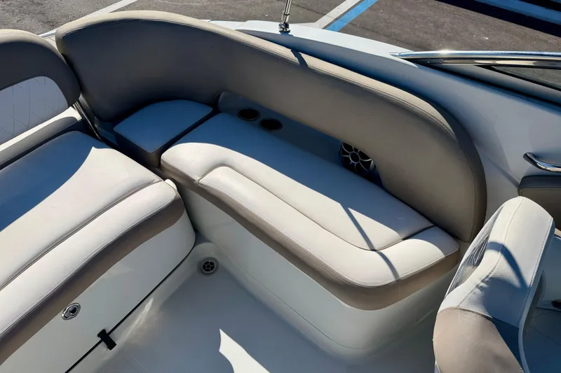 Slide: The Image of 2023 Crownline Eclipse E235 XS boat interior with cushioned seating and cup holders. - 25