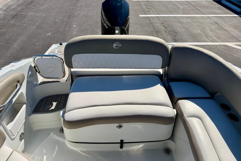 Slide: The Image of 2023 Crownline Eclipse E235 XS boat interior with cushioned seating and storage. - 28