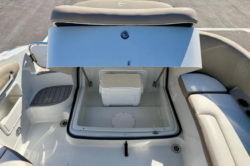 Slide: The Image of 2023 Crownline Eclipse E235 XS boat storage compartment with cooler. - 29