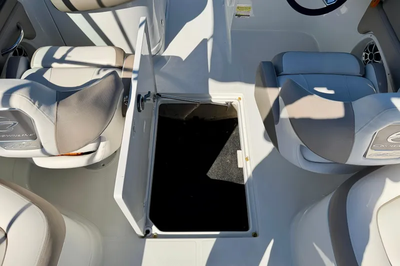 Slide: The Image of 2023 Crownline Eclipse E235 XS boat interior with open storage compartment. - 31