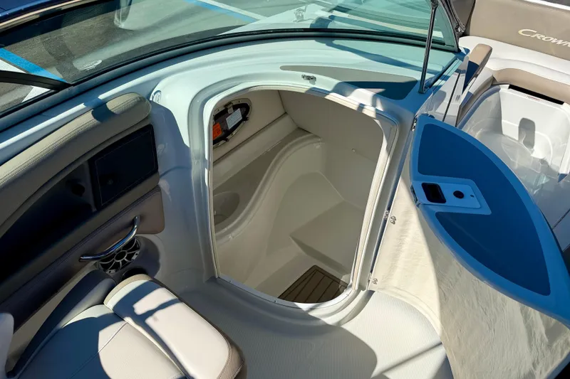 Slide: The Image of 2023 Crownline Eclipse E235 XS boat interior with open storage compartment. - 32