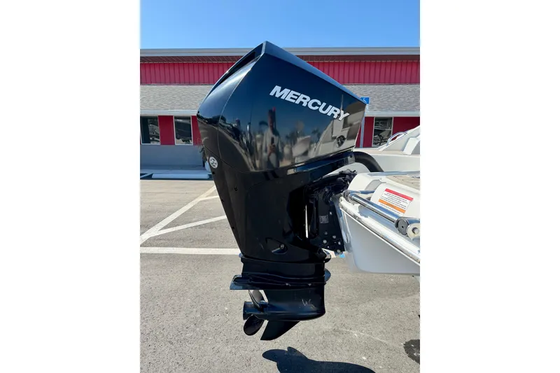 Slide: The Image of 2023 Crownline Eclipse E235 XS with Mercury outboard motor in a parking lot. - 38
