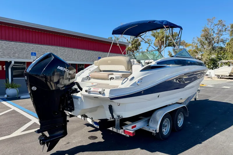 Slide: The Image of 2023 Crownline Eclipse E235 XS boat on trailer with Mercury outboard motor. - 5