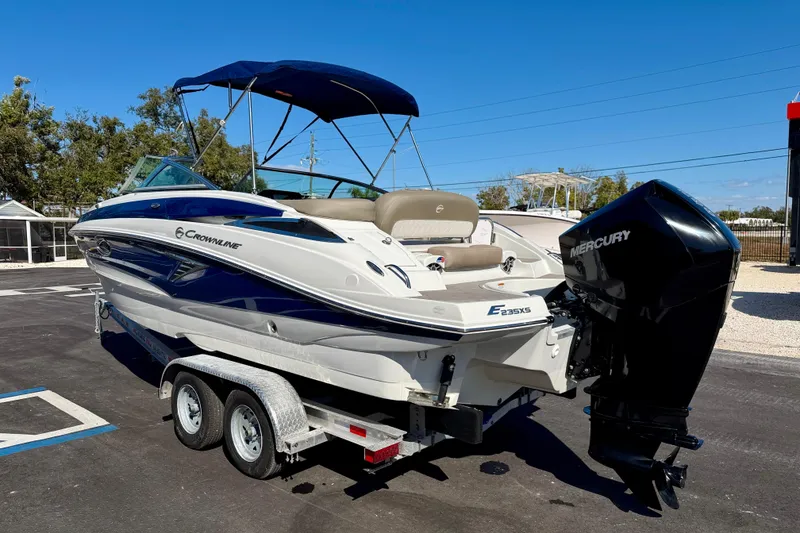Slide: The Image of 2023 Crownline Eclipse E235 XS boat on trailer with Mercury outboard motor. - 7