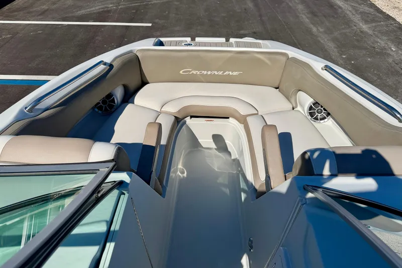 Slide: The Image of 2023 Crownline Eclipse E235 XS boat interior with cushioned seating and speakers. - 8