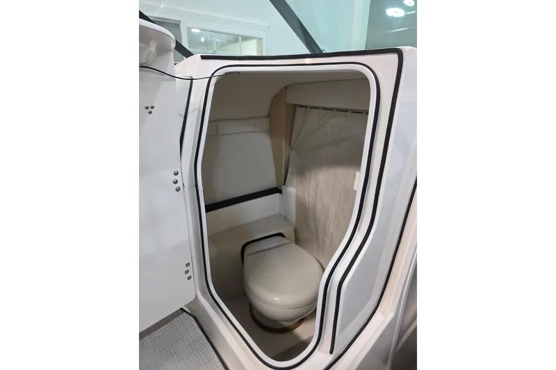 Slide: The Image of Compact bathroom inside 2026 Regal LS4C boat, featuring modern design and amenities. - 11