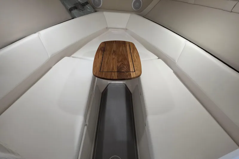 Slide: The Image of Luxurious interior of 2026 Regal LS4C boat with elegant seating and wooden table. - 14