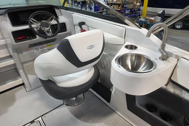 Slide: The Image of 2026 Regal LS4C boat interior with steering wheel, captain's chair, and sink. - 8