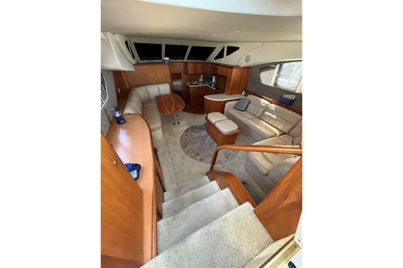 Slide: The Image of Luxurious interior of 2002 Silverton 39 Motor Yacht with plush seating and wood finishes. - 17
