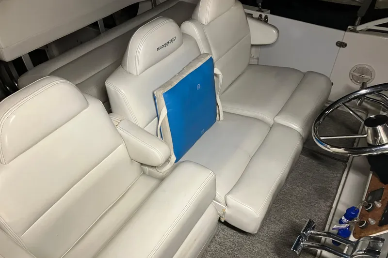 Slide: The Image of 2002 Silverton 39 Motor Yacht interior with white leather seating and steering wheel. - 8