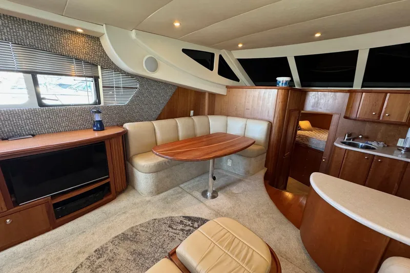 Slide: The Image of Luxurious 2002 Silverton 39 Motor Yacht interior with cozy seating and modern amenities. - 25