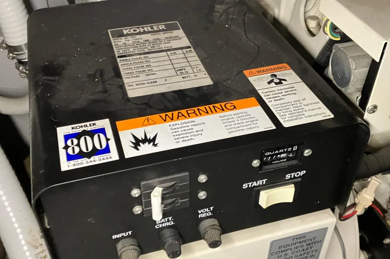 Slide: The Image of Kohler generator control panel on a 2002 Silverton 39 Motor Yacht, featuring warning labels. - 47