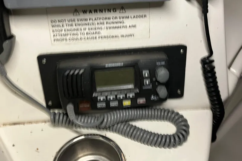 Slide: The Image of 2002 Silverton 39 Motor Yacht radio and warning label on control panel. - 13