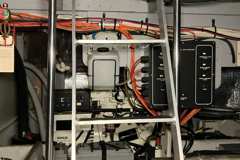 Slide: The Image of Engine room of 2002 Silverton 39 Motor Yacht with wiring and control panels. - 50