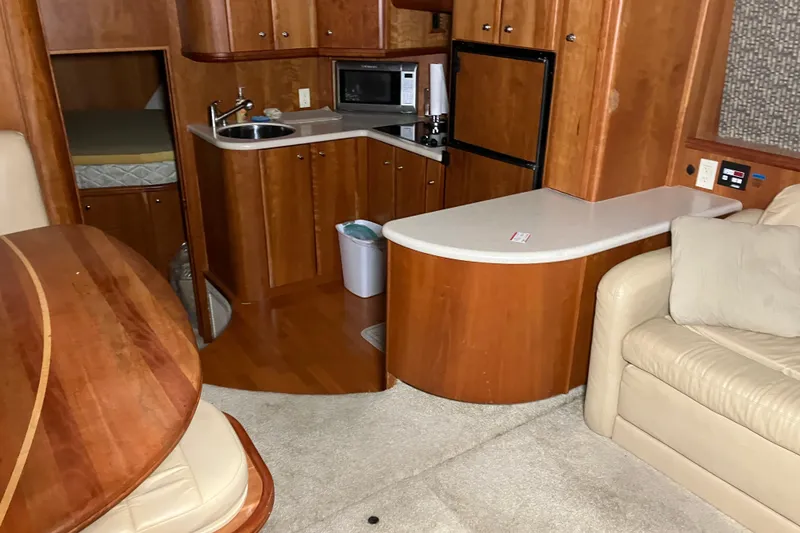 Slide: The Image of Interior of 2002 Silverton 39 Motor Yacht with kitchenette and seating area. - 23