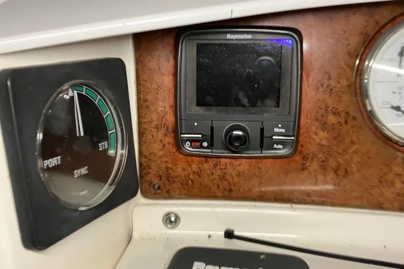 Slide: The Image of 2002 Silverton 39 Motor Yacht dashboard with Raymarine display and gauges. - 15