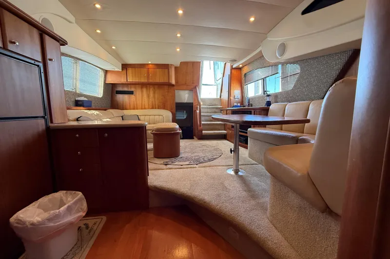 Slide: The Image of Luxurious interior of a 2002 Silverton 39 Motor Yacht with elegant seating and wood finishes. - 27