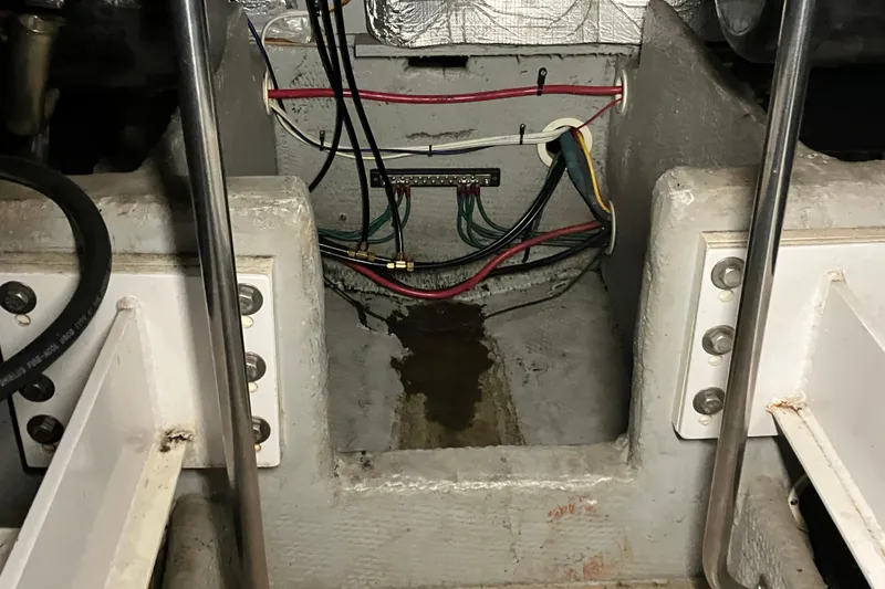Slide: The Image of Engine compartment of a 2002 Silverton 39 Motor Yacht with visible wiring and components. - 56