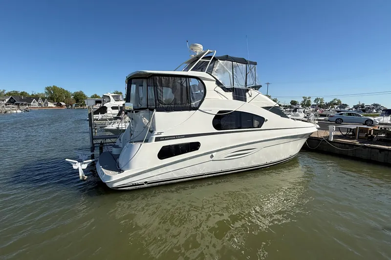 Slide: The Image of 2002 Silverton 39 Motor Yacht docked on a sunny day, showcasing sleek design and spacious cabin. - 64