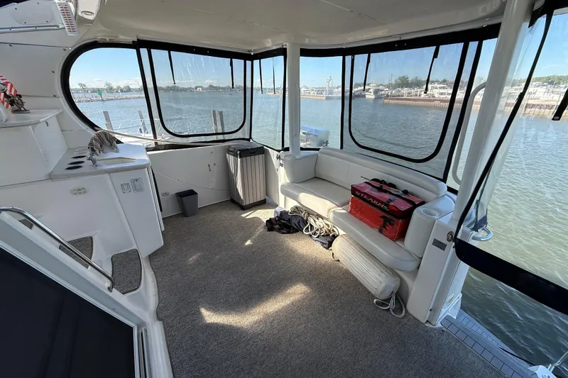 Slide: The Image of Interior of 2002 Silverton 39 Motor Yacht with spacious seating and waterfront view. - 4