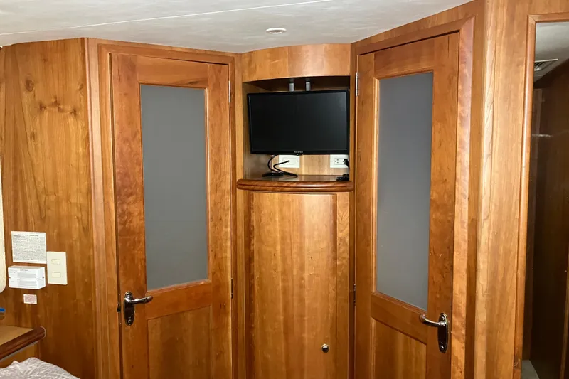Slide: The Image of Interior of 2002 Silverton 39 Motor Yacht with wooden cabinetry and mounted TV. - 36