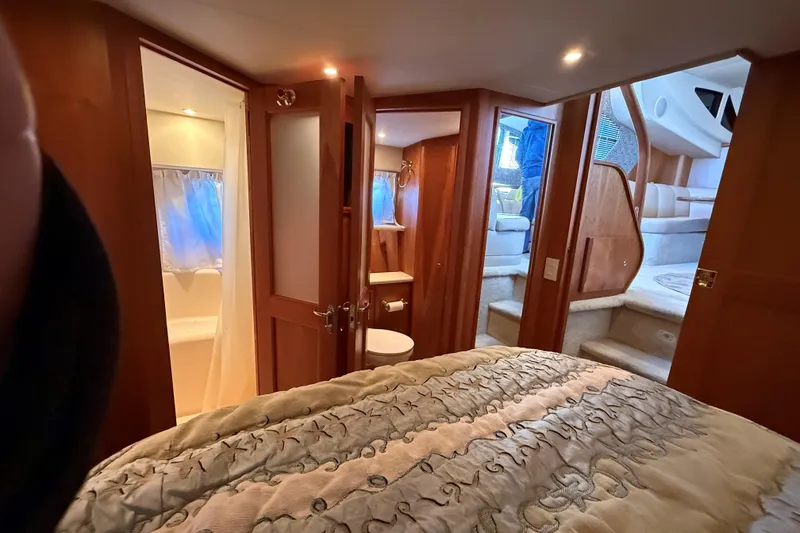 Slide: The Image of Luxurious interior of 2002 Silverton 39 Motor Yacht with cozy bedroom and elegant wood finishes. - 35