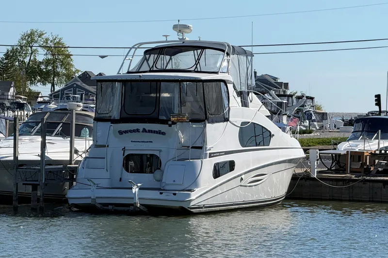 Slide: The Image of 2002 Silverton 39 Motor Yacht docked at marina, named "Sweet Annie." - 63