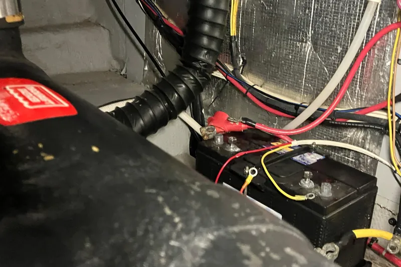 Slide: The Image of Battery compartment of a 2002 Silverton 39 Motor Yacht with wiring and connections. - 55