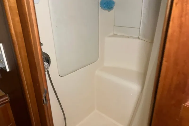 Slide: The Image of Shower area inside a 2002 Silverton 39 Motor Yacht, featuring a sleek design. - 41