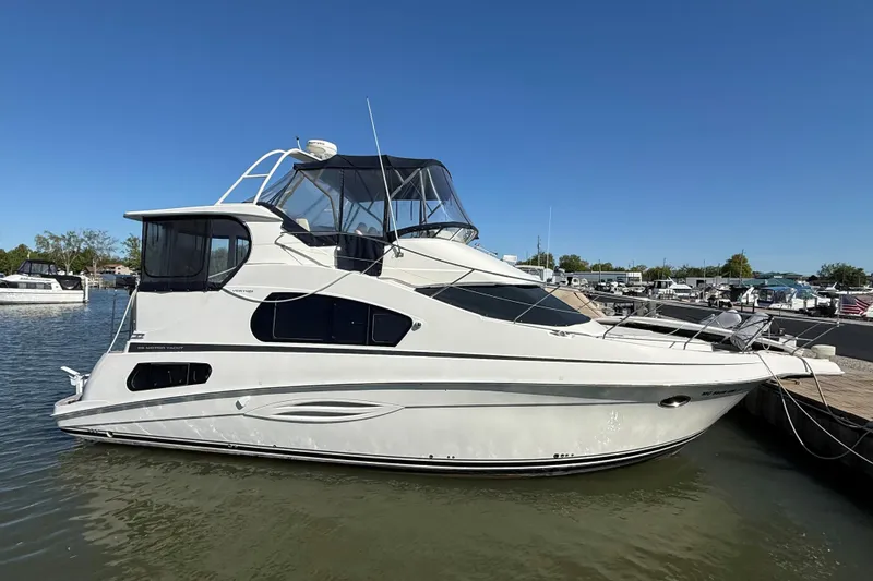 The Image of 2002 Silverton 39 Motor Yacht docked in a marina under clear blue skies. - 0