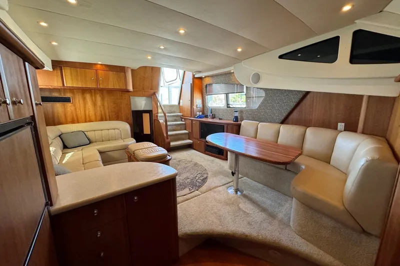 Slide: The Image of Luxurious interior of 2002 Silverton 39 Motor Yacht with plush seating and elegant wood finishes. - 18