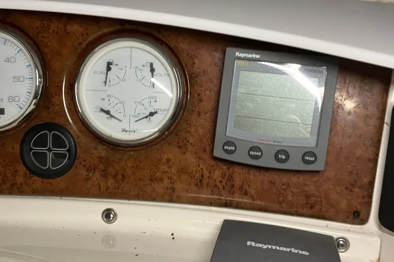 Slide: The Image of 2002 Silverton 39 Motor Yacht dashboard with gauges and Raymarine display. - 14