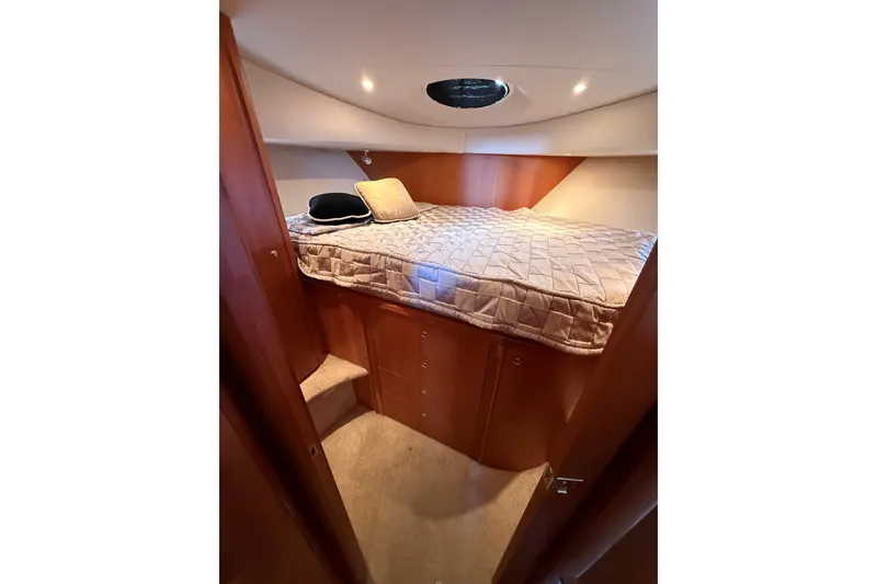Slide: The Image of Cozy cabin interior of 2002 Silverton 39 Motor Yacht with bed and wooden cabinetry. - 29