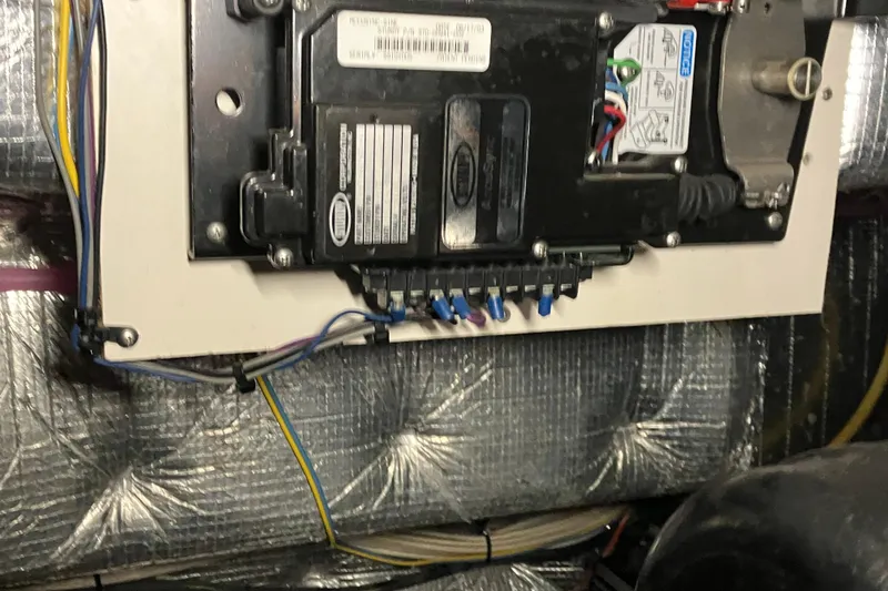 Slide: The Image of Electrical panel inside a 2002 Silverton 39 Motor Yacht, featuring wiring and components. - 52