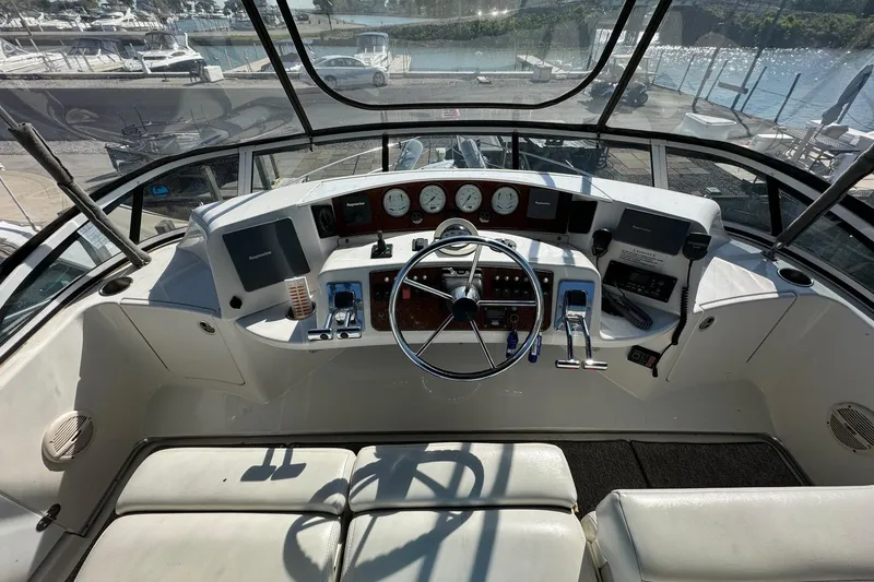 Slide: The Image of Cockpit of 2002 Silverton 39 Motor Yacht with steering wheel and control panel. - 7
