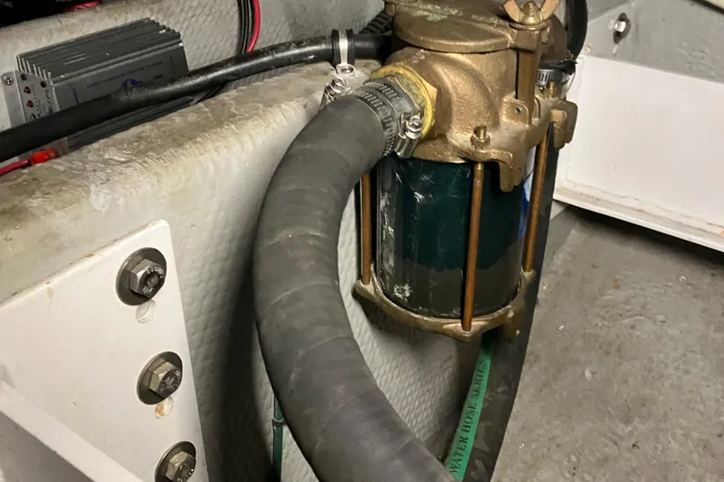 Slide: The Image of Engine room detail of a 2002 Silverton 39 Motor Yacht, showing a pump and hoses. - 46