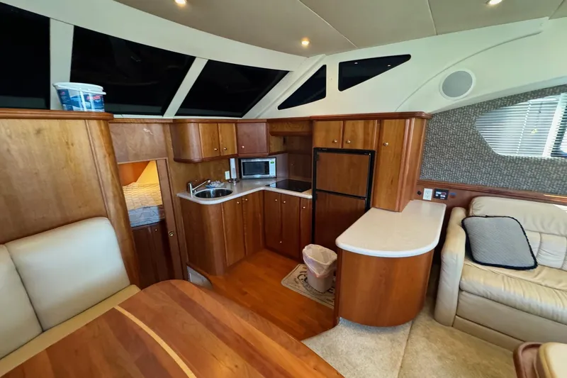 Slide: The Image of Luxurious interior of a 2002 Silverton 39 Motor Yacht with wood cabinetry and modern amenities. - 21