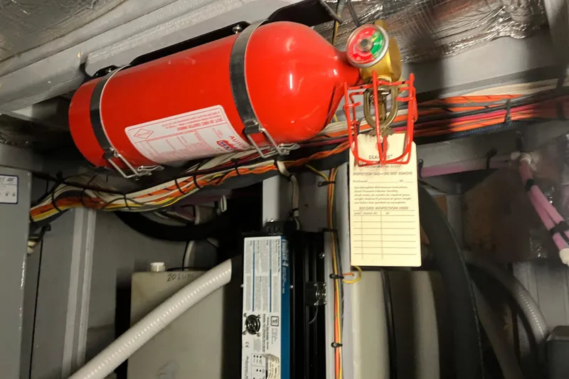 Slide: The Image of Engine room of 2002 Silverton 39 Motor Yacht with mounted fire extinguisher. - 44