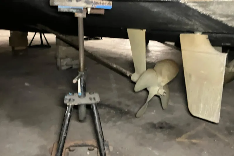 Slide: The Image of 2002 Silverton 39 Motor Yacht propeller and rudder in dry dock. - 61
