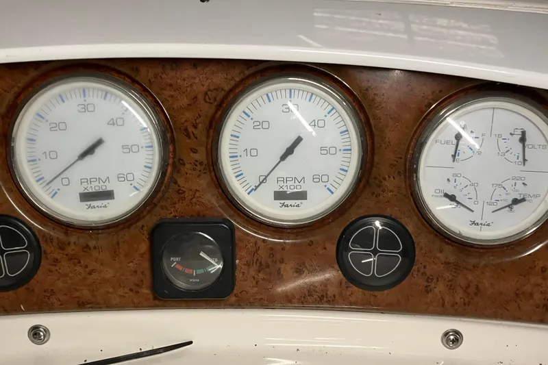 Slide: The Image of Dashboard gauges of a 2002 Silverton 39 Motor Yacht, featuring RPM and fuel indicators. - 10