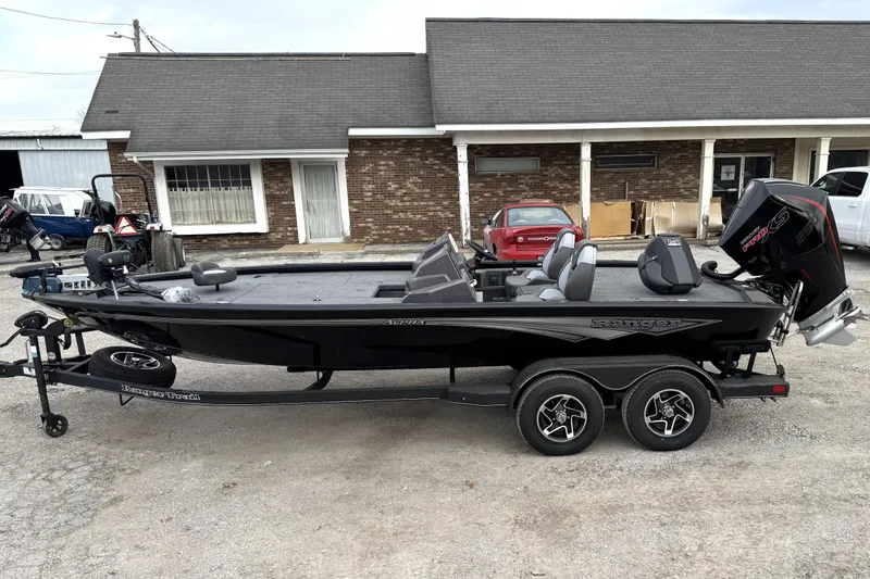 The Image of 2025 Ranger ALPHA 208 boat on trailer, parked outside a building. - 0