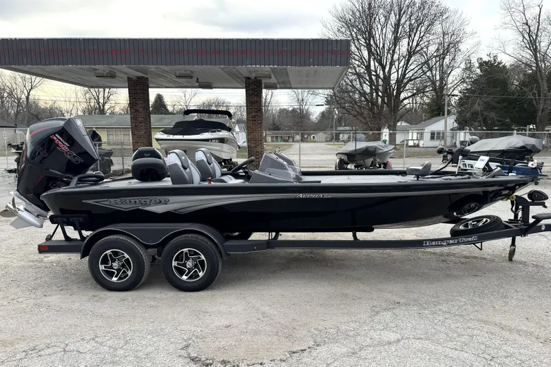 Slide: The Image of 2025 Ranger ALPHA 208 boat on trailer, parked outdoors at a dealership. - 11