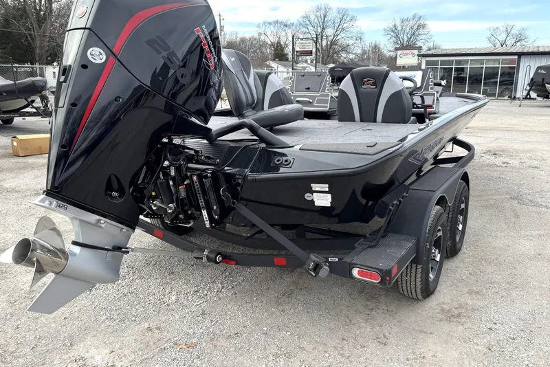 Slide: The Image of 2025 Ranger ALPHA 208 boat with powerful outboard motor, parked on a trailer. - 12