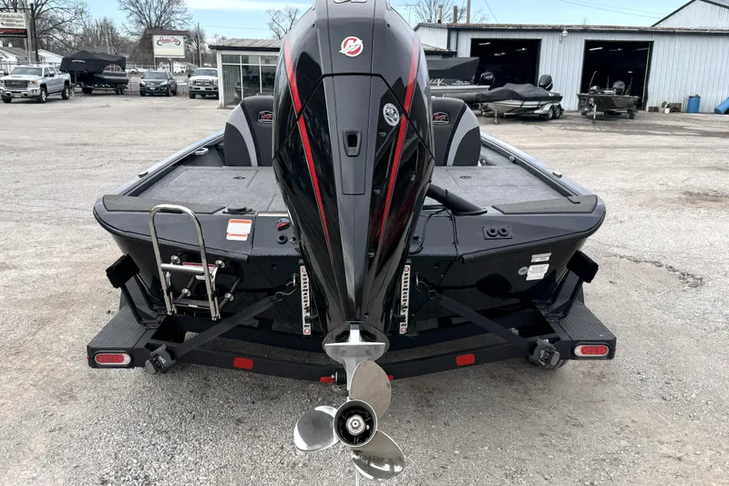 Slide: The Image of 2025 Ranger ALPHA 208 boat with powerful outboard motor, parked outdoors. - 15